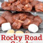 Rocky Road Candy stacked on a wooden table with mini marshmallows and peanuts