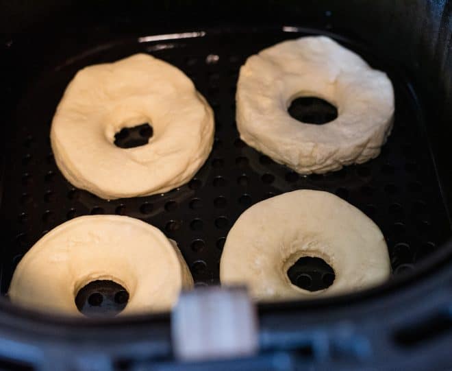 doughnuts cooking inside an air fryer