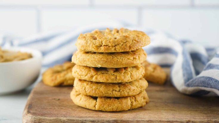 Stack of air fryer peanut butter cookies on a wooden cutting board