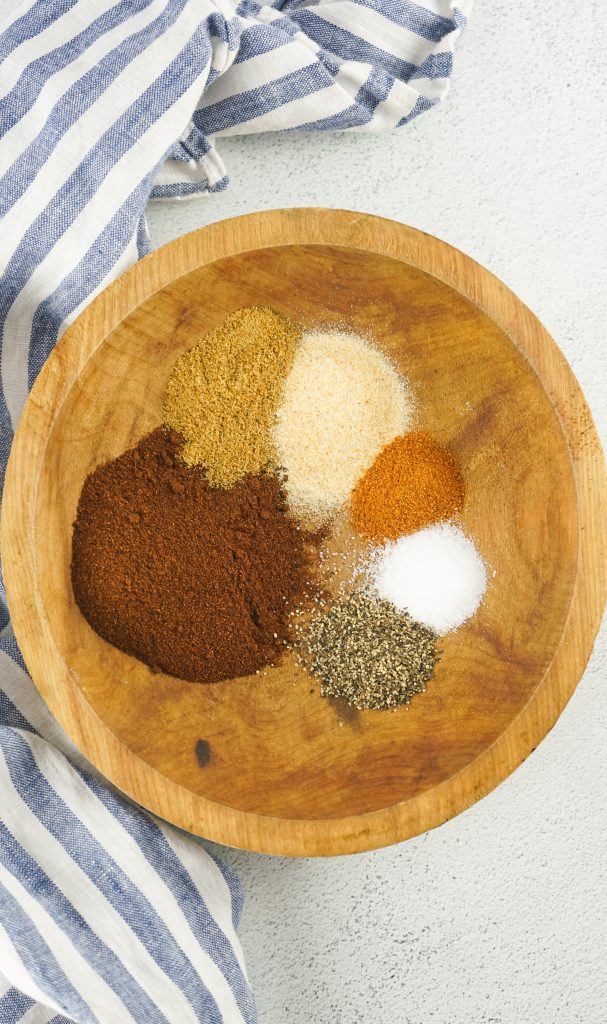 chili seasoning ingredients in a large wooden bowl