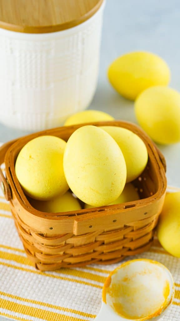 Turmeric dyed eggs in a brown basket