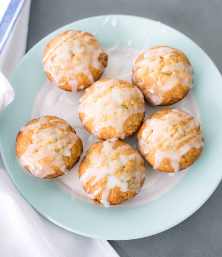 Banana Muffins With Lemon Glaze on a white and green plate