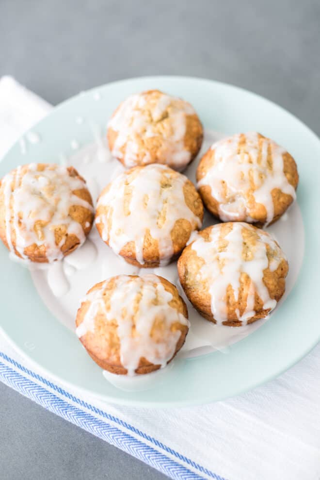 plate full of glazed banana bread muffins with lemon glaze