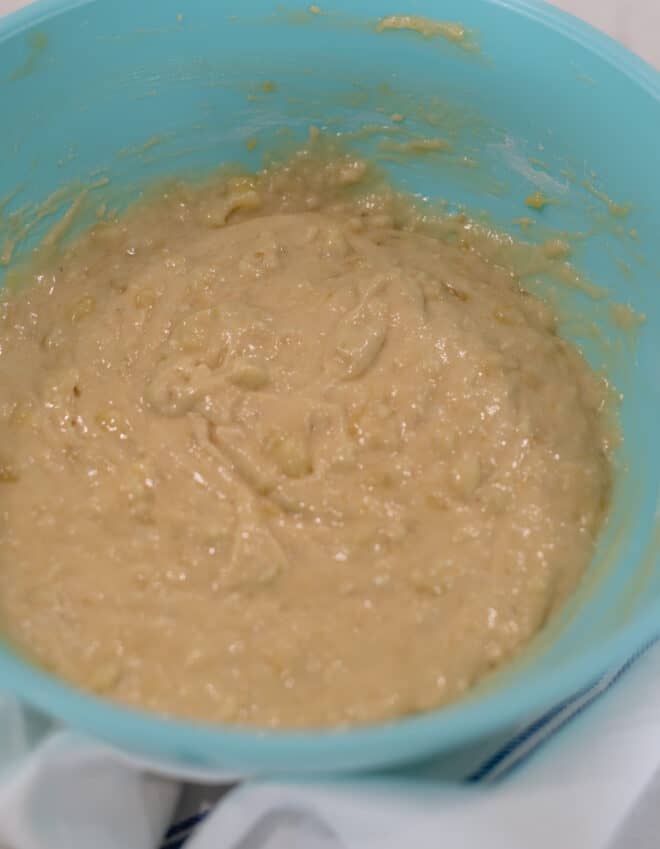 batter for best banana bread muffins in a blue bowl