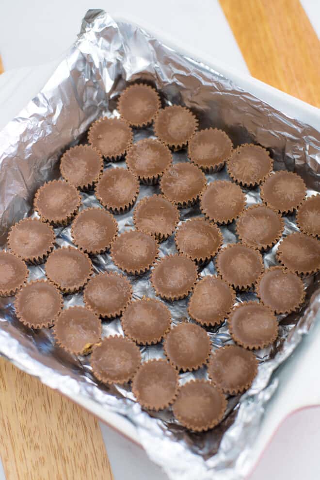 mini Reese's cups in the bottom of an 8x8 pan