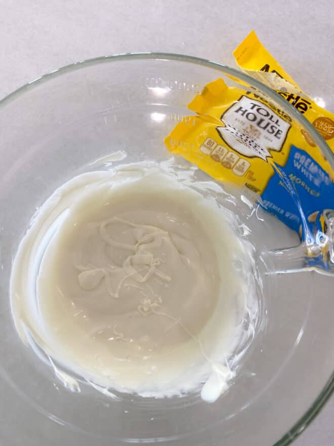 melted white chocolate morsels in a glass bowl