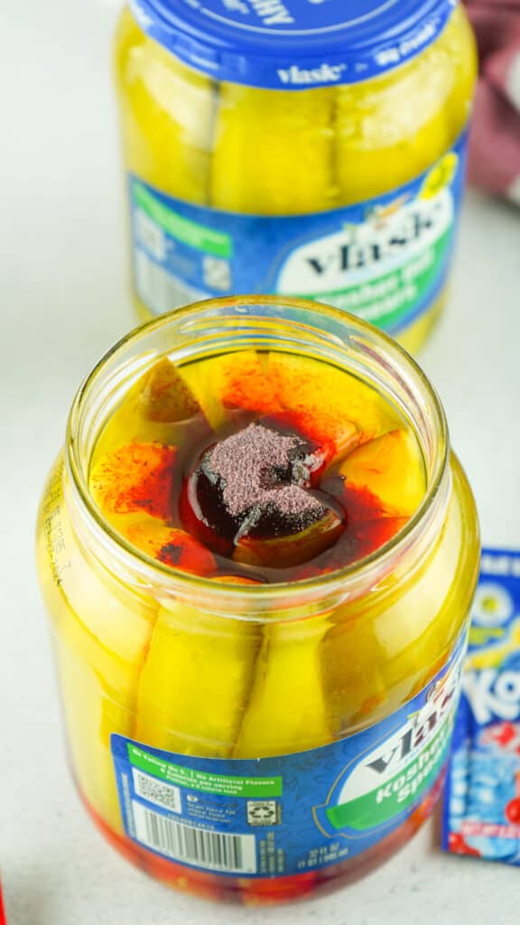 cherry Kool-Aid added to a jar of pickles