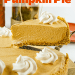 pumpkin pie with a slice being lifted out of the pie