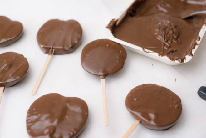 chocolate covered apple slices drying on parchment paper