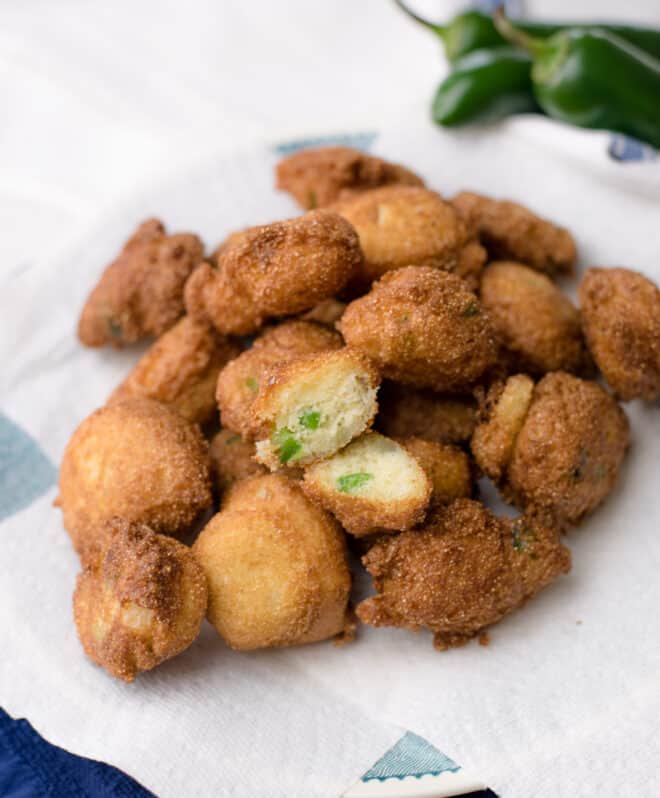 golden brown cornmeal balls on blue tray