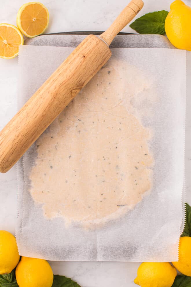 Rolling out cookie dough on a baking sheet