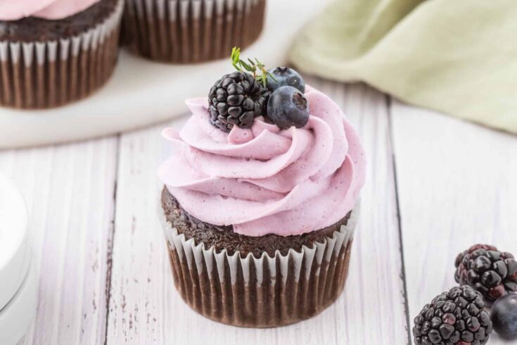 Chocolate Blackberry Cupcake on a white wooden backdrop