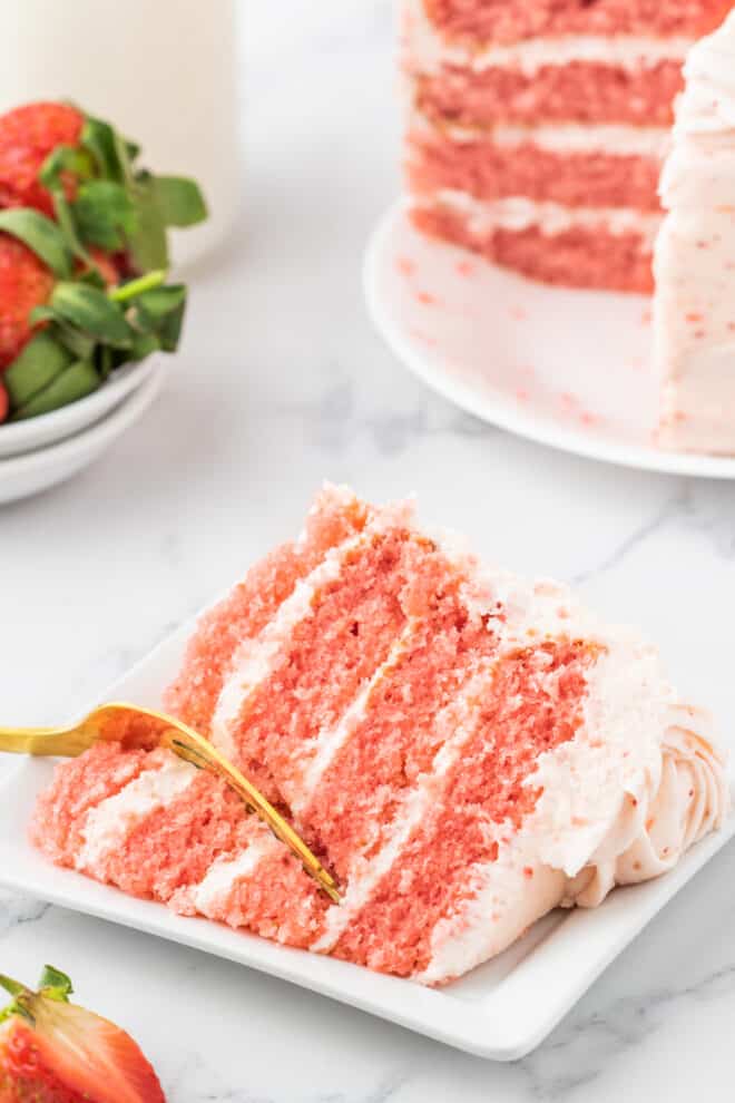 slice of strawberry cake with fork digging in!