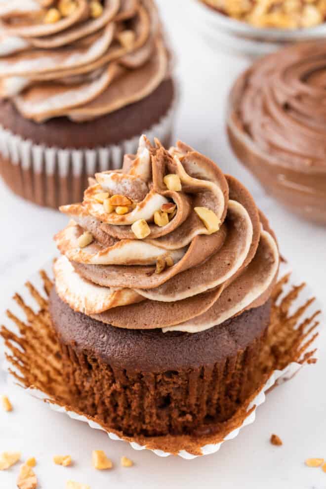 Frosted chocolate cupcakes with wrapper pulled back