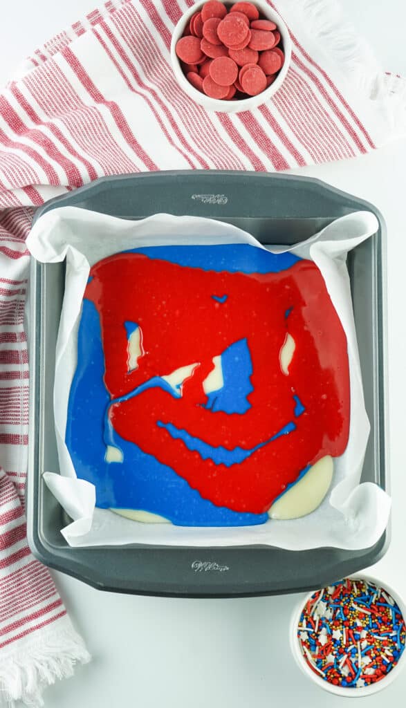 red, white and blue layers of fudge added to an 8x8 pan