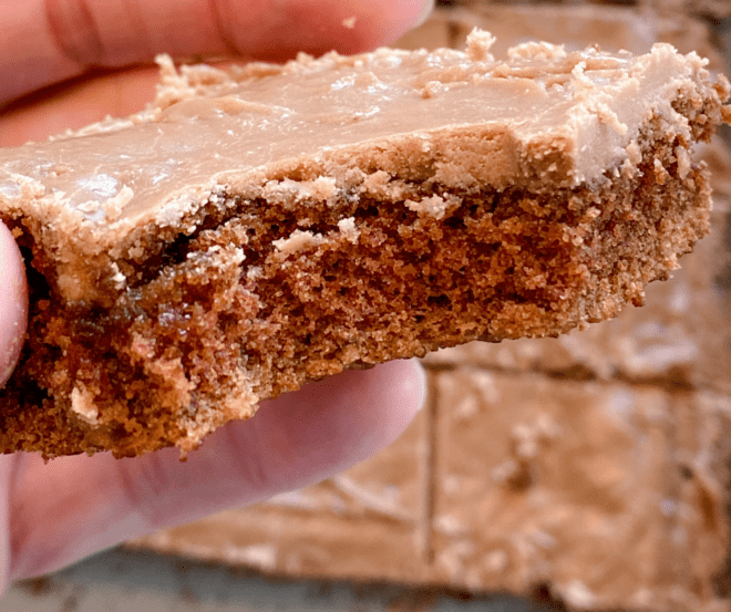 A bite taken out of a piece of chocolate sheet cake 