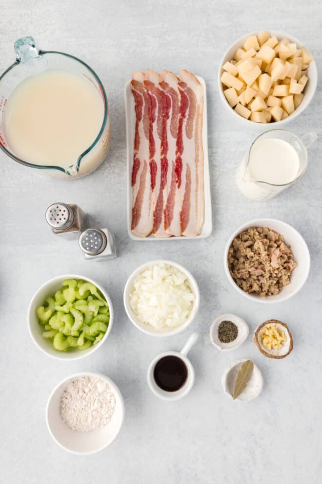 Ingredients needed to make clam chowder including bacon, heavy cream and chopped clams