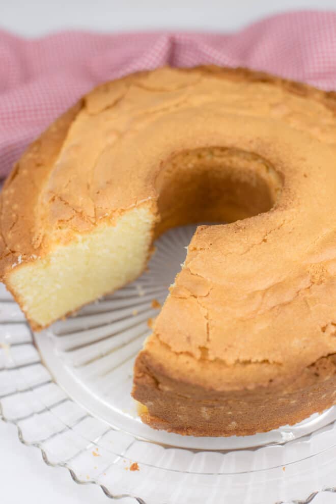 Old Fashioned Whipping Cream Pound Cake on serving platter with one piece missing