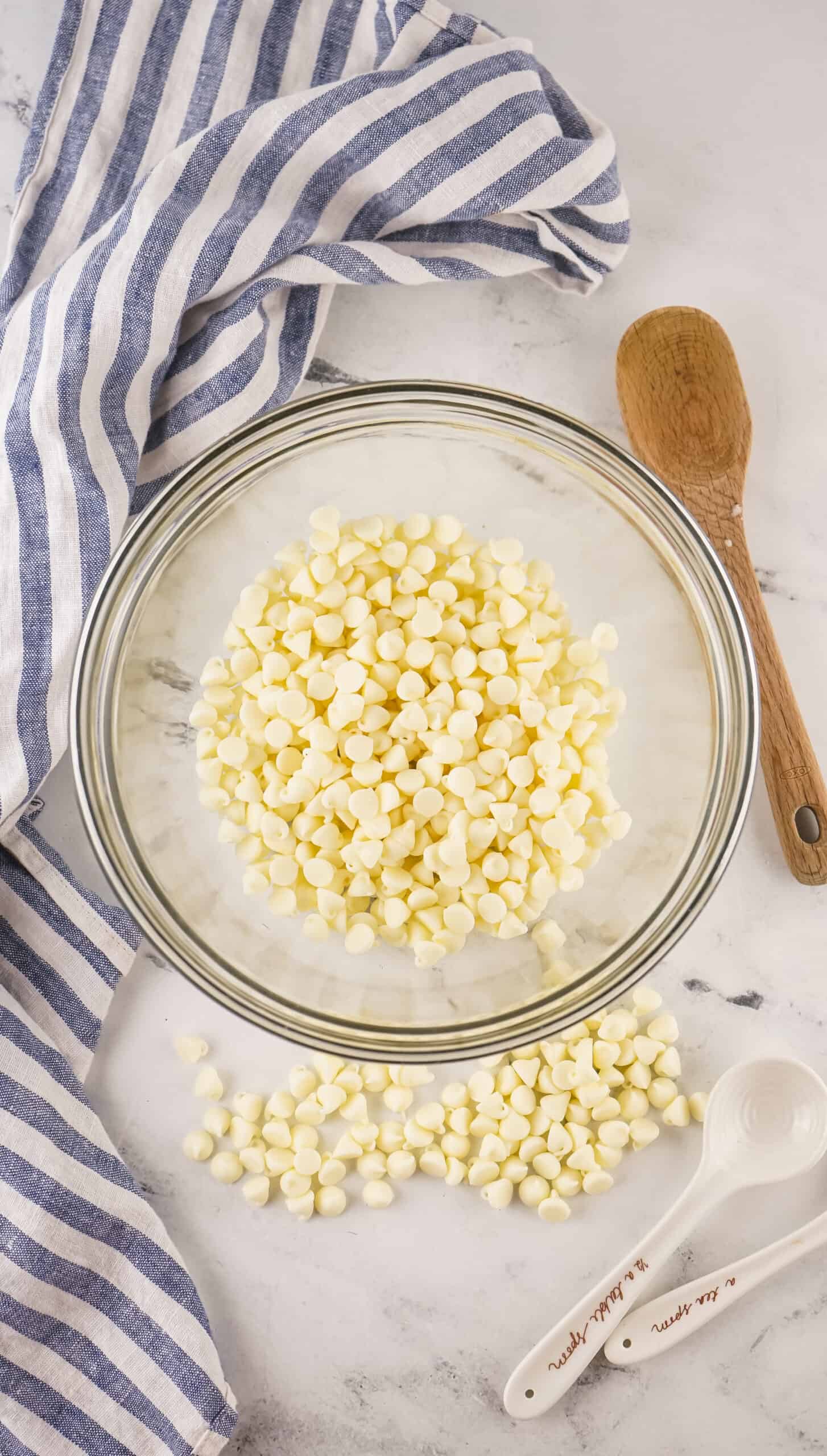 white chocolate chips in a glass bowl ready to melt in the microwave