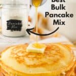 bulk pancake mix in glass container in background with a stack of pancakes in the front with text overlay