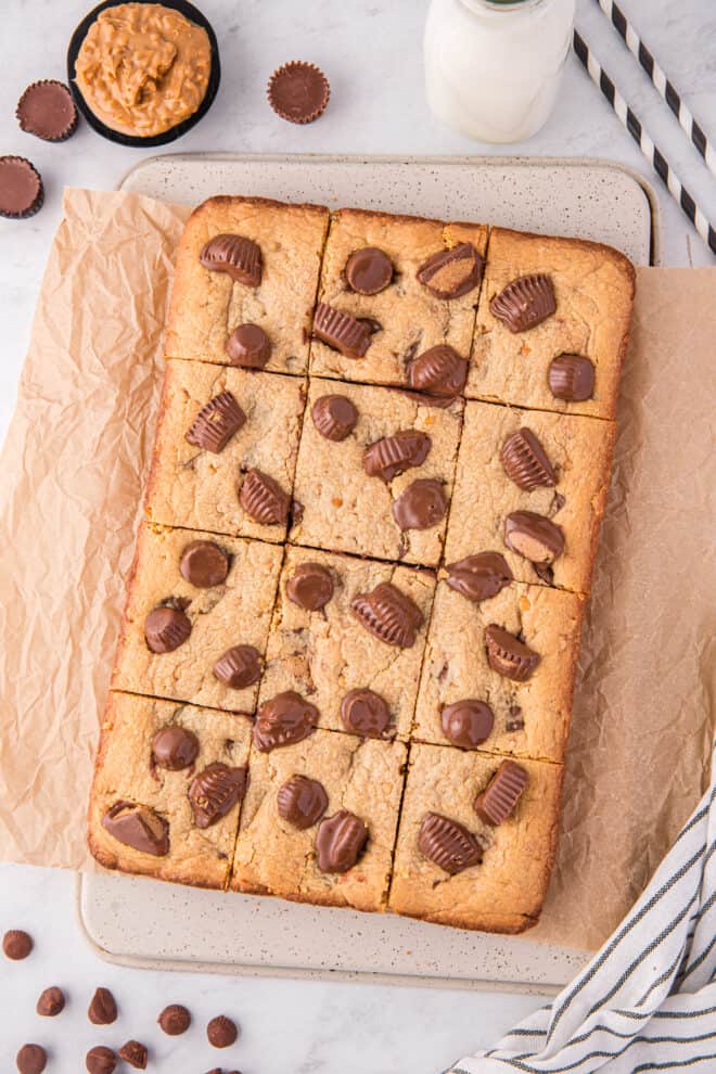 Peanut Butter Blondies With Reese's Cups cut into squares and ready to serve