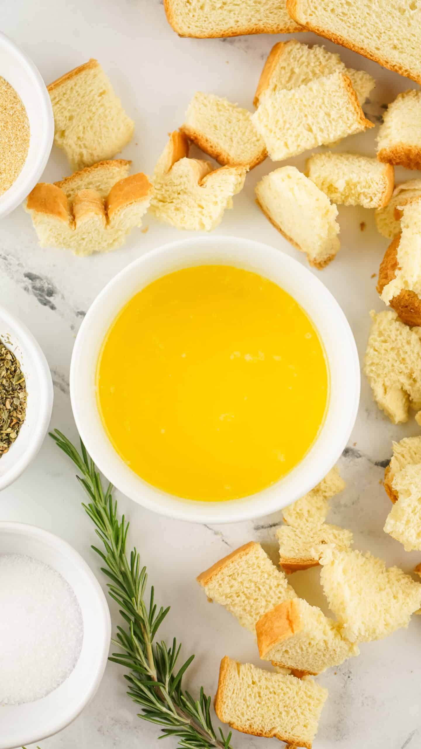 melted butter surrounded by cubed bread for homemade croutons