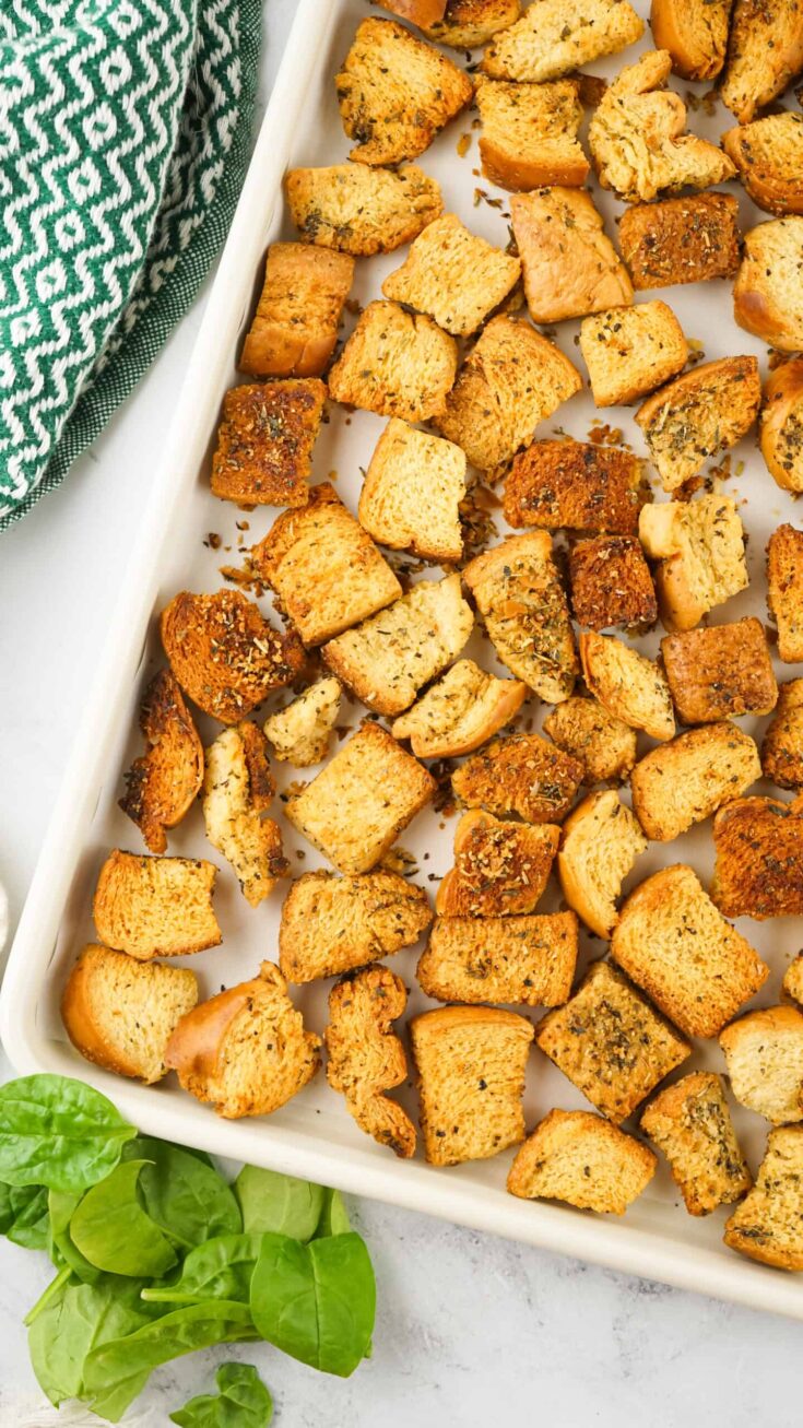 homemade Italian Seasoned Croutons on white baking dish