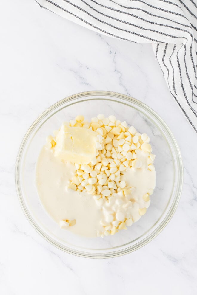 white chocolate chips, butter and cream in a glass bowl