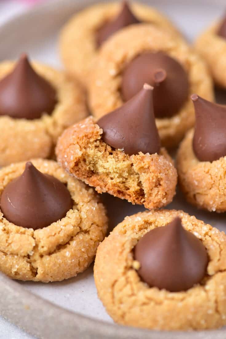 Classic Peanut Butter Blossoms stacked on a serving plate