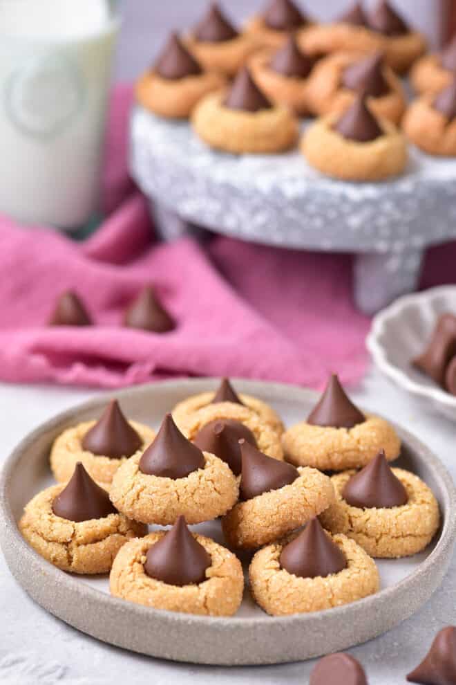 Peanut Butter Blossoms on a serving tray with more cookies in the background.