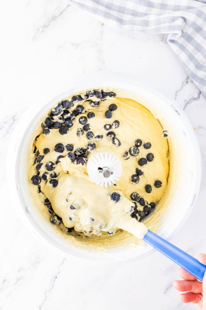 Blueberries being added to cake batter 