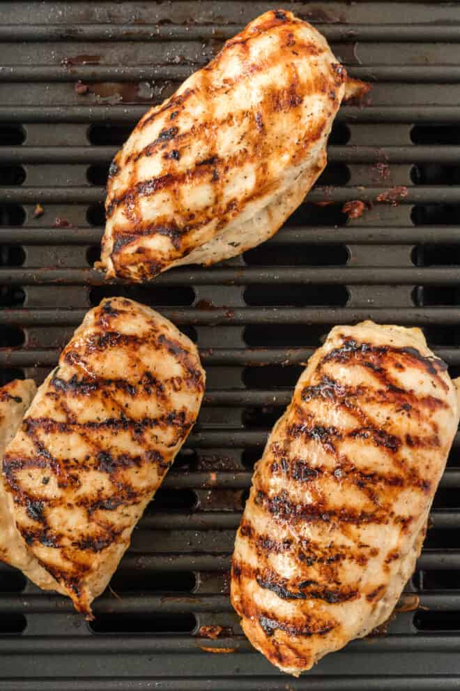 grilled chicken breasts on the grill with grill marks