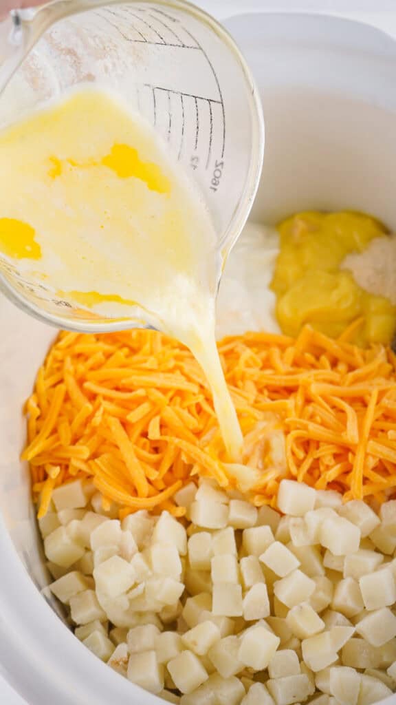 melted butter poured over ingredients in slow cooker to make funeral potatoes