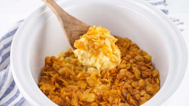 spooning up crockpot funeral potatoes to serve