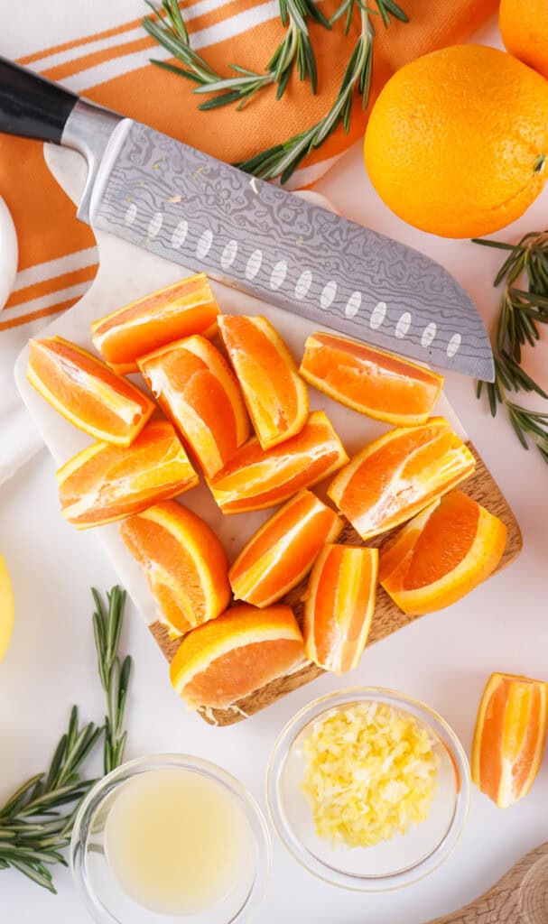 four oranges cut into wedges ready to process to make orange marmalade 