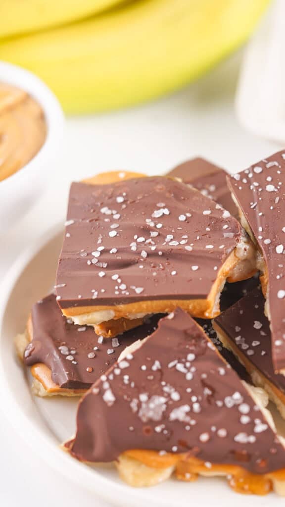 Banana Chocolate Bark broken into pieces on a white serving tray.