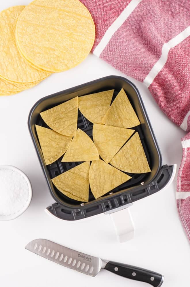 corn tortilla chips in air fryer basket before frying