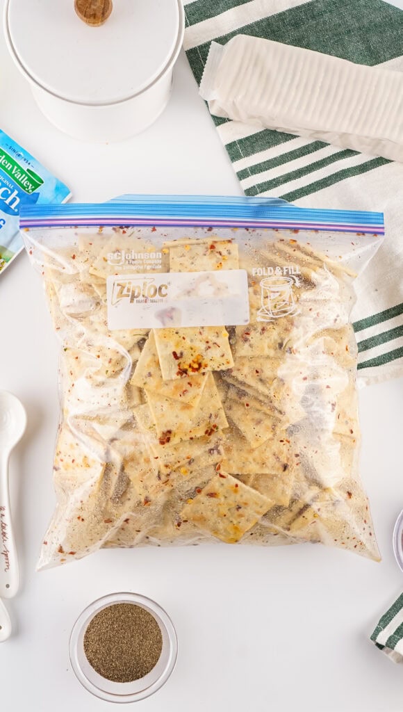 ZipLoc Bag filled with saltine crackers, seasoning and oil. Closed and ready to gently combine.