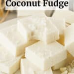 White platter piled high with creamy coconut fudge squares with text overlap for Pinterest