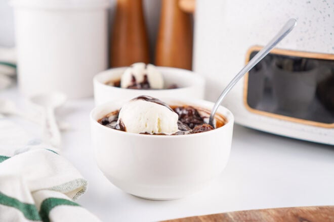side view of slow cooker chocolate cobbler in white serving bowls