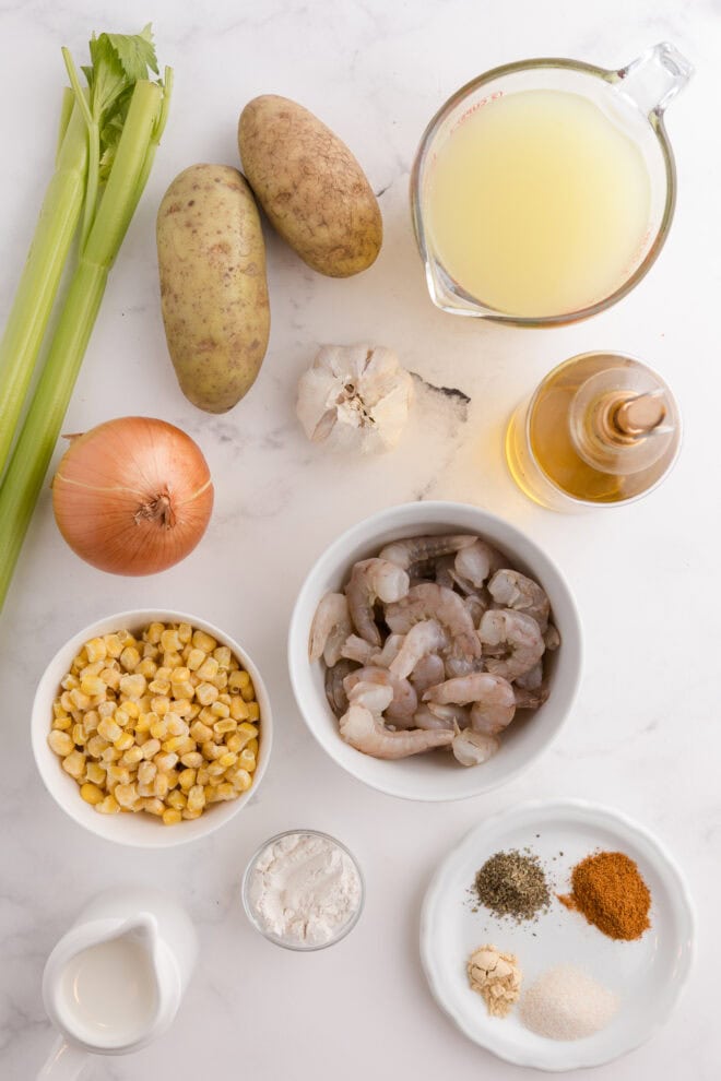 Ingredients Needed to make Shrimp Chowder including raw shrimp, corn, potatoes, onions and spices.