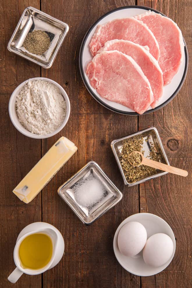 Ingredients needed to make pan fried pork chops including flour, oil and eggs.
