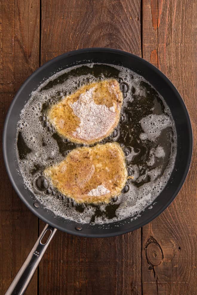 Pork Chops frying in a skillet