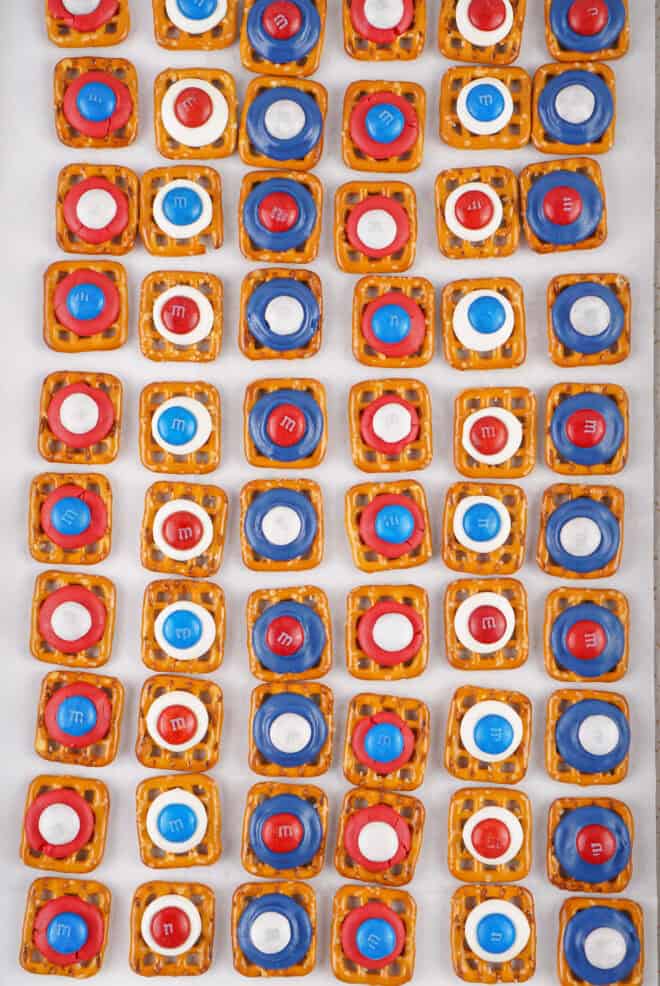 Red, White & Blue M&M's on top of candy melts, cooling on the sheet pan