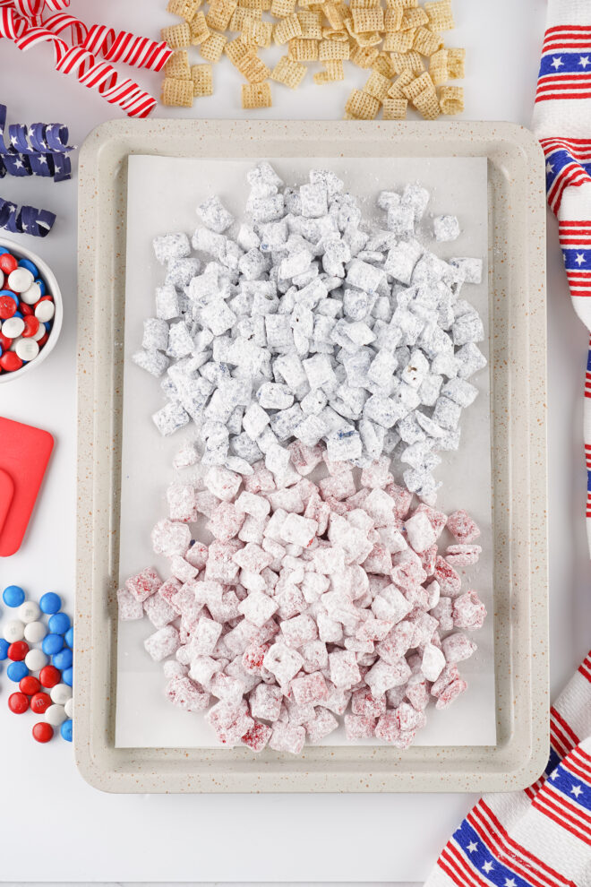 Red White and Blue Muddy Buddies resting on a baking pan to dry before serving