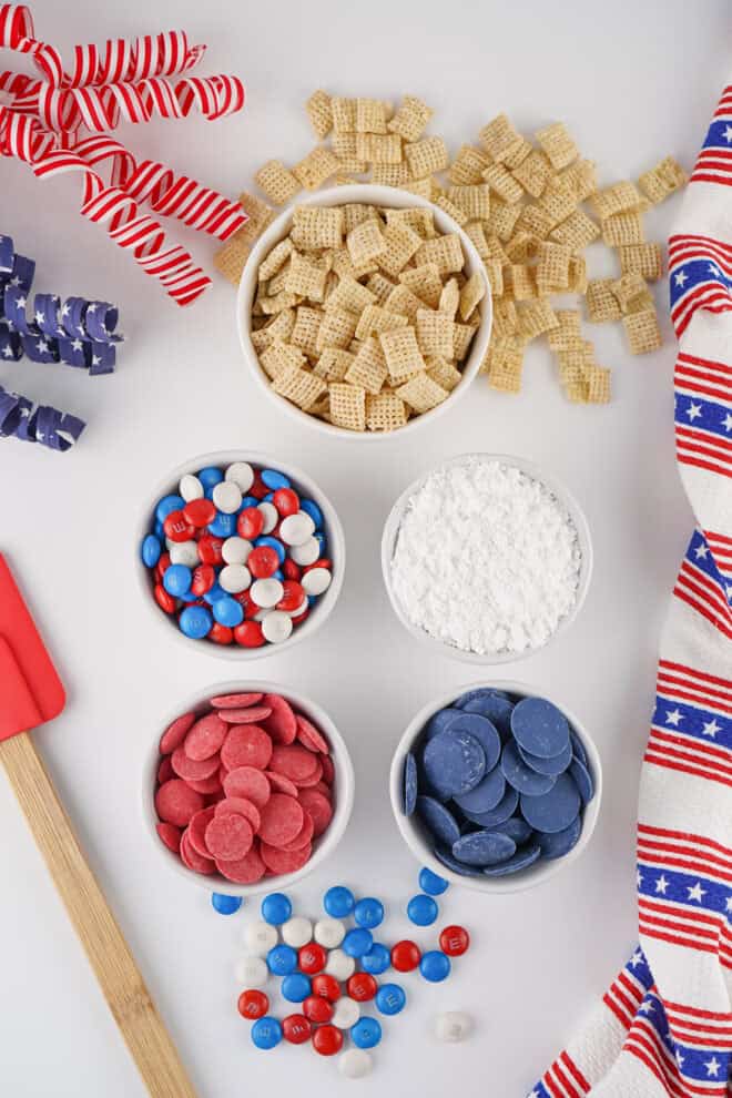 Ingredient Pic for Patriotic Muddy Buddies - Chex cereal, red and blue candy melts, powdered sugar and Red, White & Blue M&M's.