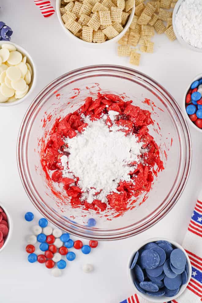 powdered sugar on top of chex cereral coated in melted red candy melts.