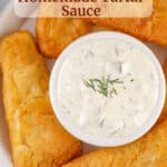 White Bowl of Homemade Tartar Sauce surrounded by crispy fried fish with text overlap for Pinterest