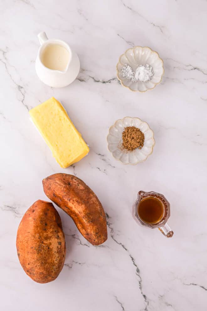 Ingredients needed to make Whipped Sweet Potatoes including melted butter and maple syrup.