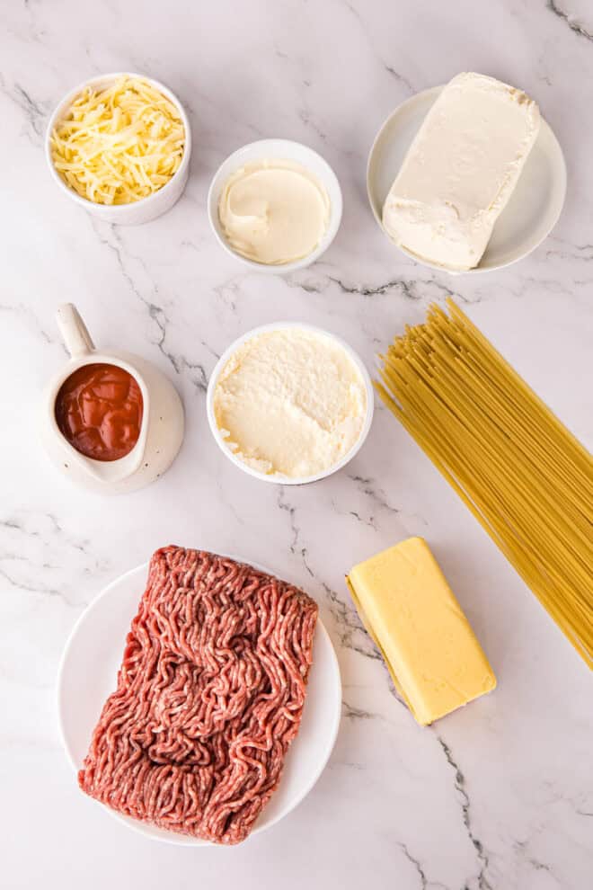 Ingredients Needed to make million dollar spaghetti including three cheeses, ground beef and cheeses